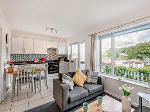 a kitchen and living room with a couch and a table at 2 Bed in Brixham oc-bx079 in Brixham