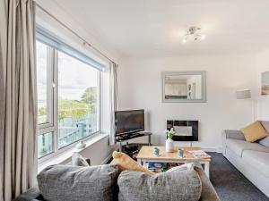 a living room with a couch and a large window at 2 Bed in Brixham oc-bx079 in Brixham