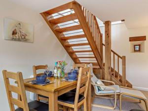 a dining room with a wooden table and chairs at 1 Bed in Ilfracombe oc-43641 in Berrynarbor