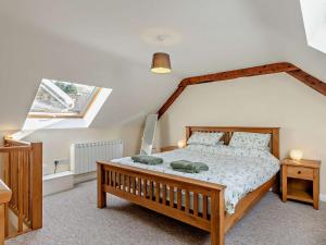 a bedroom with a large wooden bed with a window at 1 Bed in Ilfracombe oc-43641 in Berrynarbor