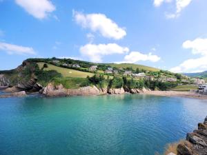 a view of a beach with houses on a hill at 1 Bed in Ilfracombe oc-43641 in Berrynarbor +8 photos