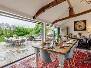 a dining room with a table and a large window at 5 Bed in Dulverton oc-41133 in Brushford