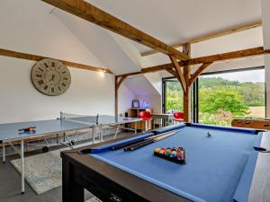 a room with a pool table and a clock at 5 Bed in Dulverton oc-41133 in Brushford
