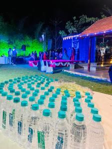 a bunch of empty water bottles sitting on a table at 1000 SILVERS -Farm Stay in Mysore