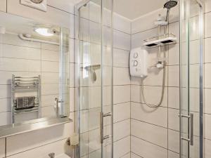 a bathroom with a shower with a glass door at 1 Bed in Llangollen oc-92336 in Llangollen