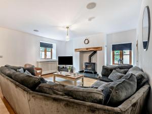a living room with a large couch and a fireplace at 4 Bed in Ilfracombe oc-95899 in Berrynarbor