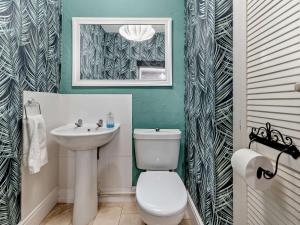 a bathroom with a white toilet and a sink at 4 Bed in Ilfracombe oc-95899 in Berrynarbor +22 photos