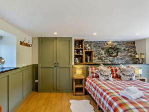 a bedroom with a bed and a stone wall at 2 Bed in Llanidloes oc-95815 in Llanidloes