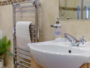 a white sink in a bathroom with a shower at 2 Bed in Llanidloes oc-95815 in Llanidloes +25 photos