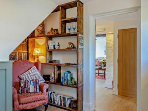a room with a book shelf filled with books at 2 Bed in Llanidloes oc-95815 in Llanidloes