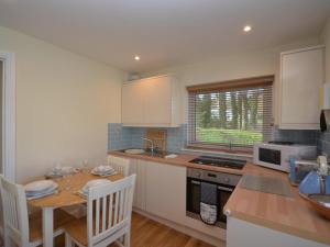a kitchen with a table and a counter top at 2 Bed in Brixham oc-bx054 in Brixham