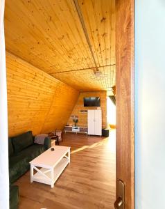 a living room with a couch and a table at Șoaptele Naturii A-frame in Buzău +54 photos