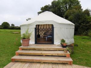 a gazebo with a wooden deck in a field at 1 Bed in Llandysul oc-85415 in Rhyd Owen