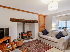a living room with a couch and a fireplace at 2 Bed in South Molton oc-55221 in Bishops Nympton