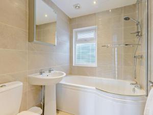 a bathroom with a tub and a sink and a toilet at 2 Bed in Okehampton oc-74242 in Okehampton +6 photos