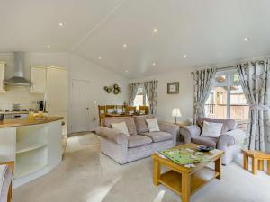 a living room with two couches and a kitchen at 2 Bed in Okehampton oc-85432 in Okehampton