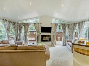a living room with a couch and a fireplace at 2 Bed in Okehampton oc-85432 in Okehampton