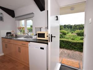 a kitchen with a microwave on a counter with a window at 2 Bed in Tiverton oc-shayn in Huntsham +9 photos