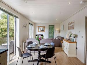 a kitchen and living room with a table and chairs at 2 Bed in Conwy oc-50284 in Llangelynin