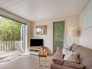 a living room with a couch and a television at 2 Bed in Conwy oc-50284 in Llangelynin