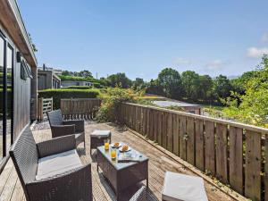 a patio with chairs and a table on a deck at 2 Bed in Conwy oc-50284 in Llangelynin