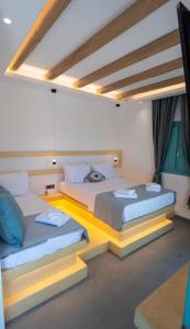 two beds in a room with two bedsitures at Casa Elezi in Koufonisia