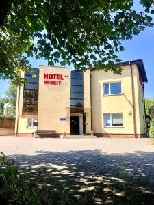 a hotel building with a sign on the front of it at Pokoje Hotelowe Norbit in Grodzisk Mazowiecki