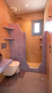 a bathroom with a sink and a toilet and a shower at Casa Elezi in Koufonisia +19 photos