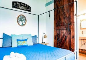 a bedroom with a blue bed with a wooden door at Rivers Edge Lofts - Unit 2 in Niles +33 photos