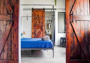 a bedroom with a bed and a wooden door at Rivers Edge Lofts - Unit 2 in Niles
