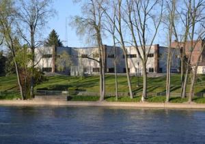 a building next to a body of water at Rivers Edge Lofts - Unit 2 in Niles
