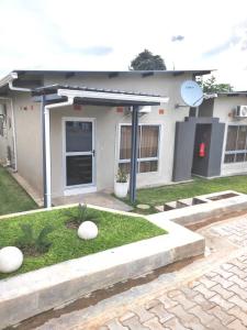a small house with a garden in front of it at Nkambo Apartments in Kitwe