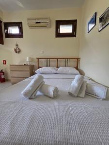 a bedroom with a large bed with white sheets and pillows at Sea Nest Studio 1 in Agia Ermioni