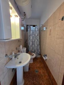 a bathroom with a sink and a toilet at Sea Nest Studio 1 in Agia Ermioni