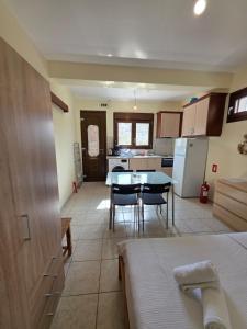 a kitchen with a table and chairs in a room at Sea Nest Studio 1 in Agia Ermioni +12 photos