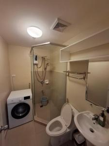 a bathroom with a shower and a toilet and a sink at Avida Storeys 2 7th Floor in Iloilo City