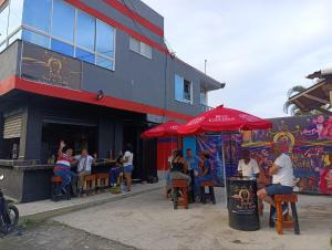 a group of people sitting outside of a restaurant at Hotel Pablo's in Tumaco +18 photos