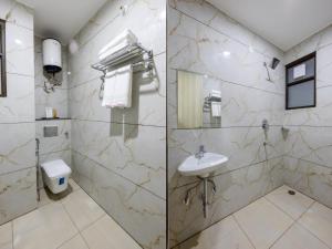 a bathroom with a sink and a toilet at Expressway Hotel - Yashobhoomi, Dwarka in New Delhi
