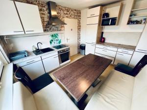 a small kitchen with a wooden table and chairs at Monteur Unterkunft 6 Betten in Karben
