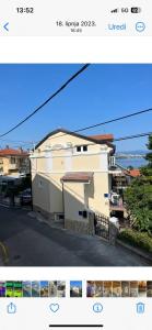 a picture of a white house with a street at Amorino Apartman Studio in Opatija