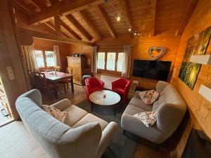 a living room with two couches and a television at Blockhaus Noffke in Stamsried