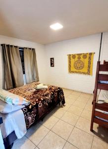 a bedroom with a bed in a room at Pousada Uluwatu, Praia do Rosa in Praia do Rosa +33 photos