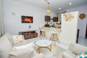 a living room with a couch and a table at Diani Dream stays 2 in Diani Beach