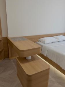 a bedroom with a bed and a table next to it at KSWL Residence in Long Bình