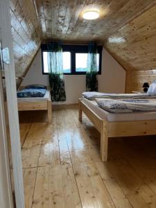 a bedroom with two beds in a wooden house at Kuća Sunny Rudnik in Rudnik +14 photos