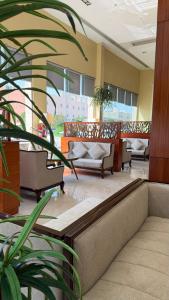 a lobby with couches and a plant at Noon Hotel Suites in Khafji