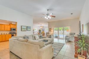 a living room with a couch and a ceiling fan at Private Pool + Patio: Pensacola Family Home! in Perdido Key