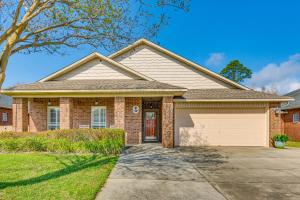 a brick house with a garage at Private Pool + Patio: Pensacola Family Home! in Perdido Key