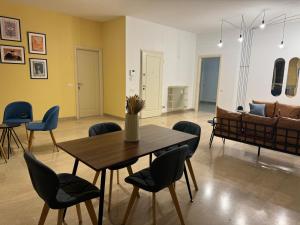 a room with a table and chairs and a couch at FEEL - Bellavista Suites in Bergamo
