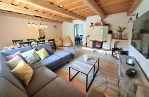 a living room with a couch and a fireplace at apartmány TASIA in Mýto pod Ďumbierom